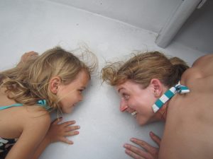 Listeners hear the song of a humpback whale through the deck of the boat